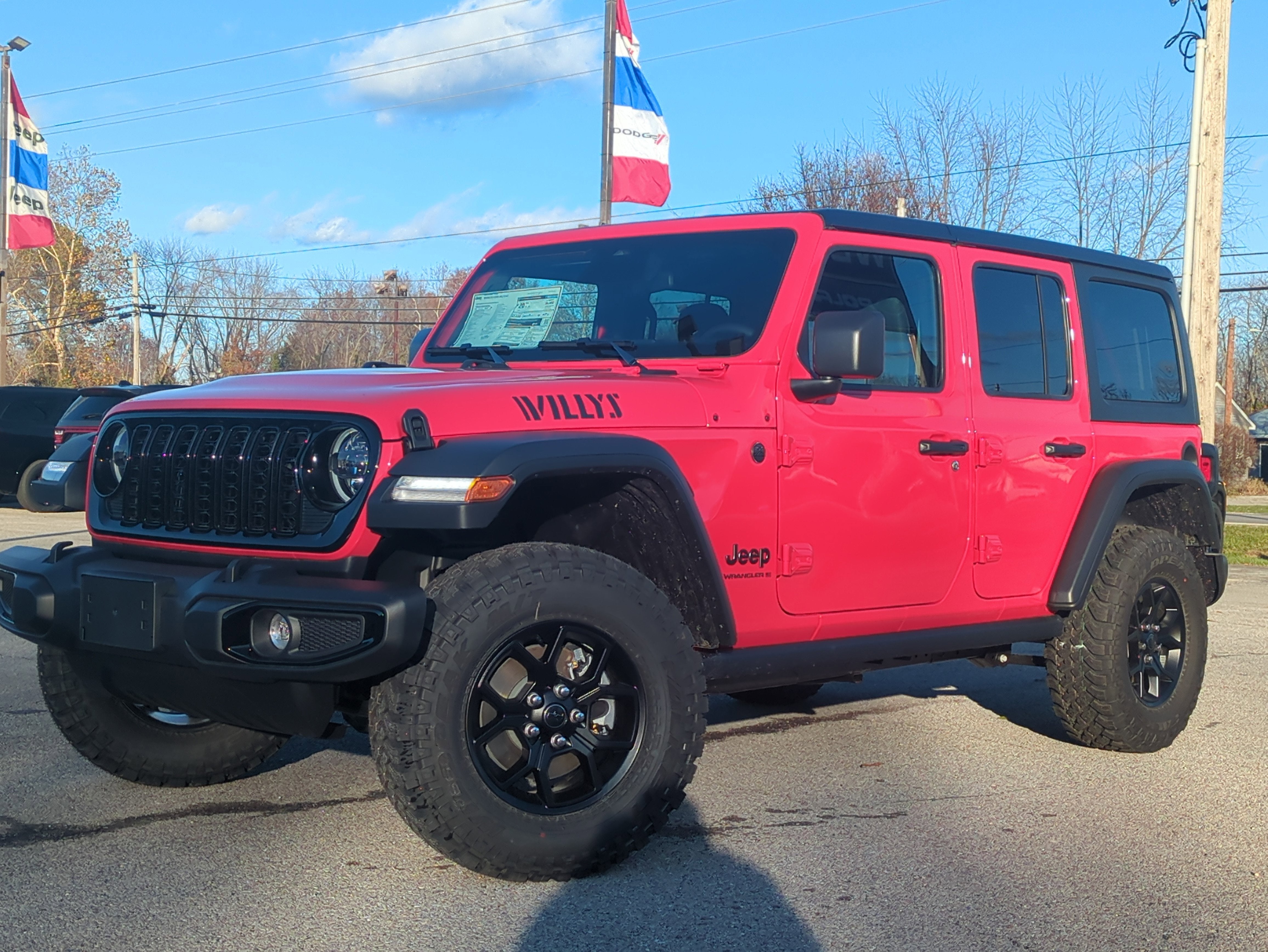 2026 Jeep Wrangler WRANGLER 4-DOOR WILLYS in Firecracker Red Clear-Coat Exterior Paint — front three-quarter view