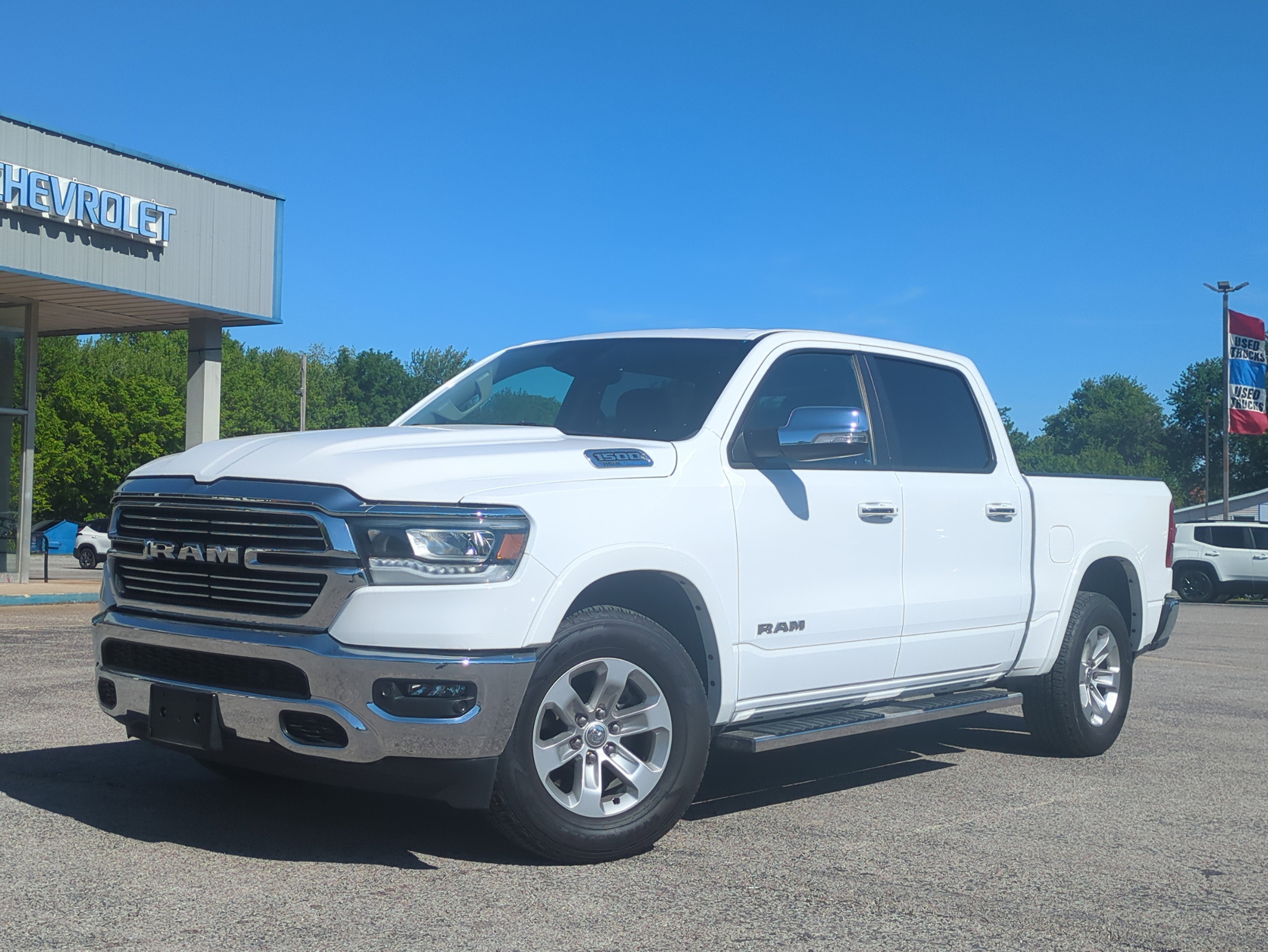 2022 RAM 1500 Laramie Crew Cab 4x4 5'7' Box in Bright White Clearcoat — front three-quarter view