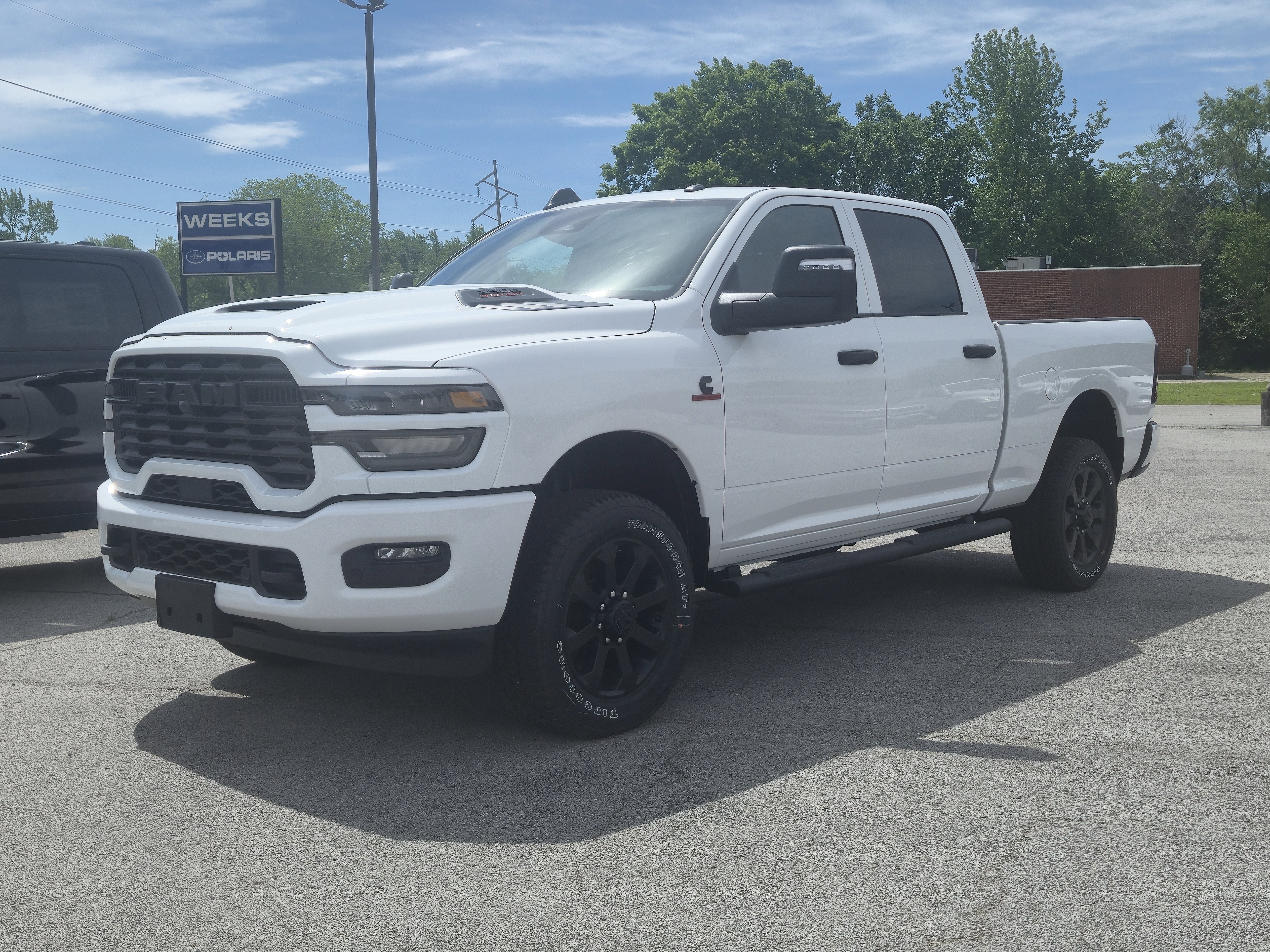 2026 RAM Ram 2500 RAM 2500 BLACK EXPRESS CREW CAB 4X4 6'4' BOX in Bright White Clear-Coat Exterior Paint — front three-quarter view