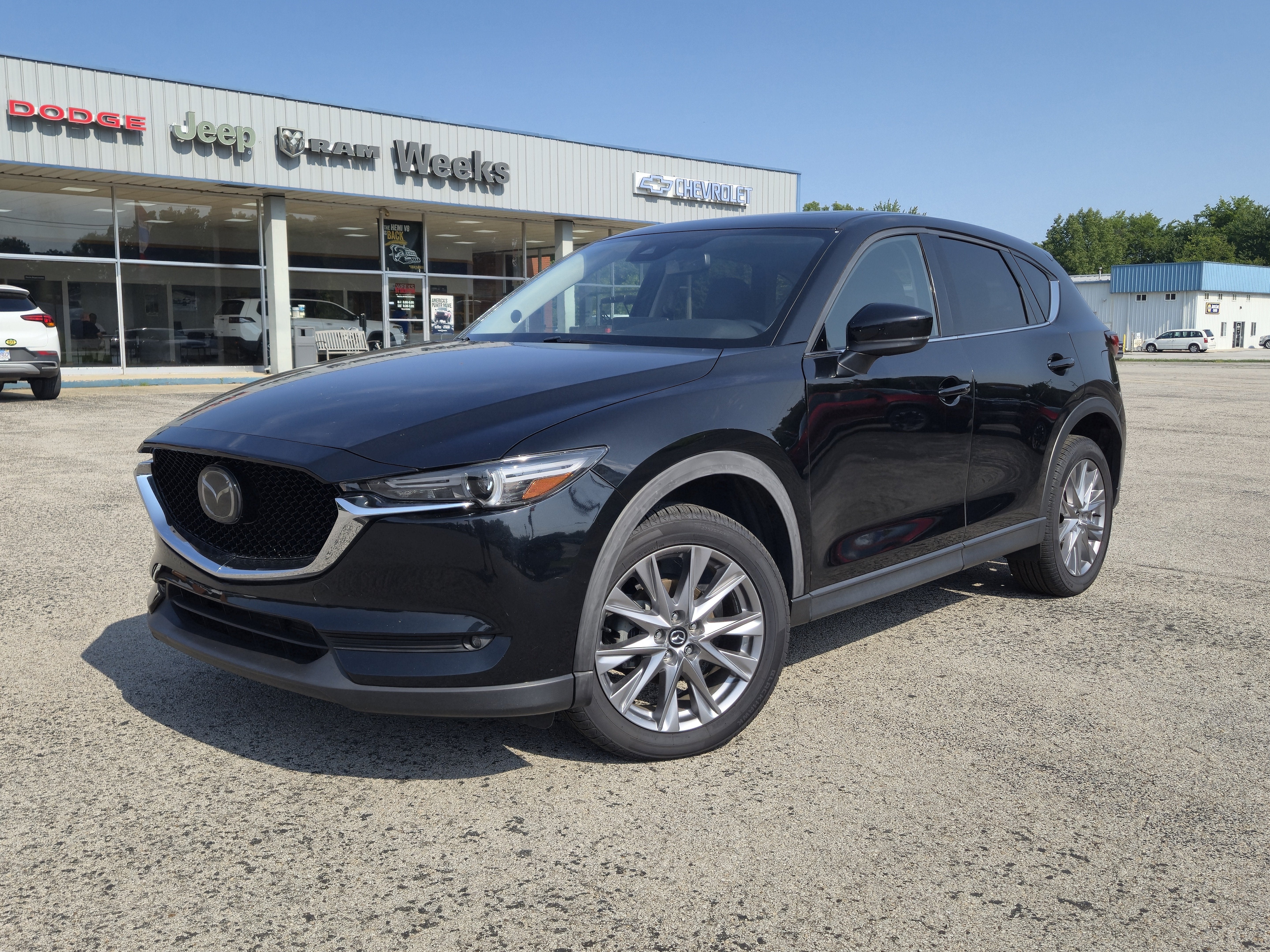 2021 Mazda Mazda CX-5 Grand Touring in Jet Black Mica — front three-quarter view